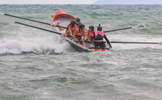 Surf boat crashing through wave